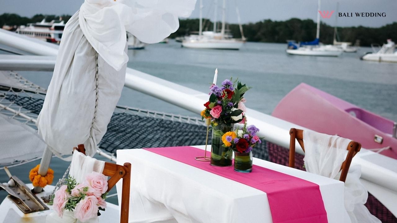 Romantic table on a yacht decorated with flowers