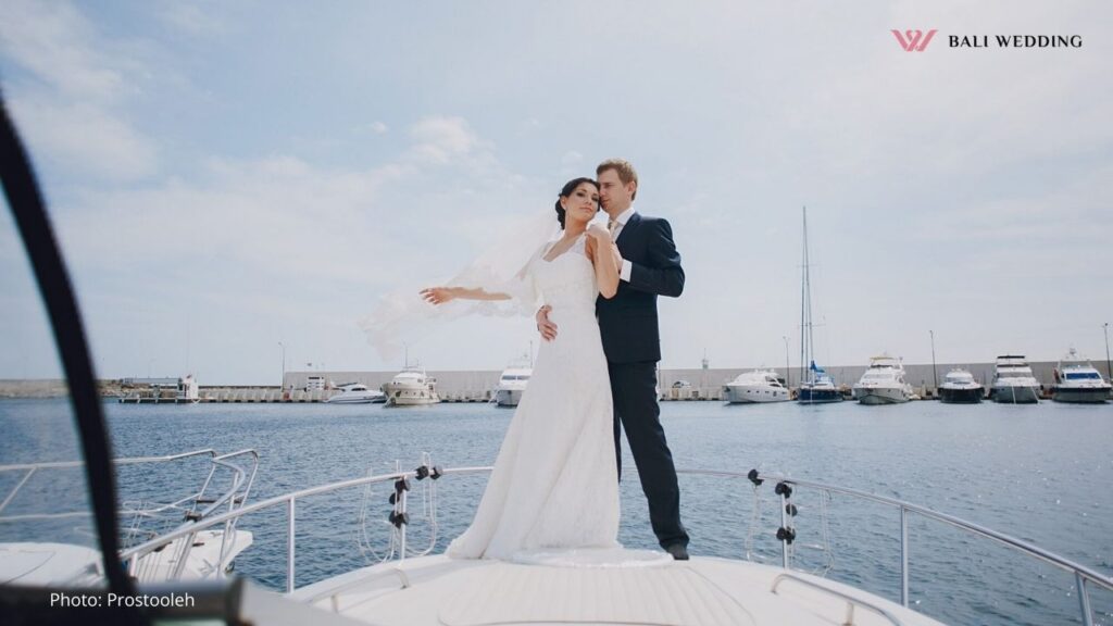 Wedding couple on a yacht enjoying the ocean view