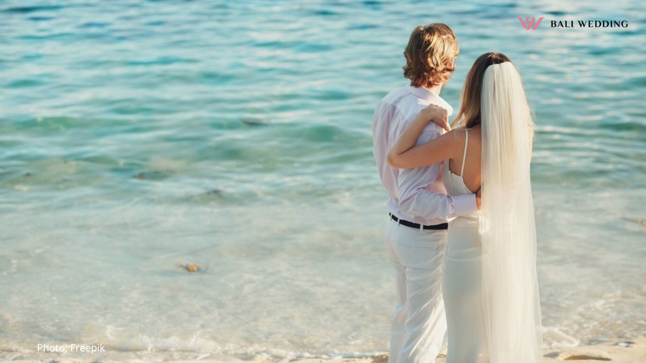 A Couple of a Beach Helding a Wedding