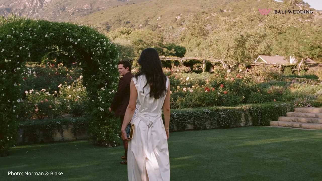 Couple strolling in garden with archway