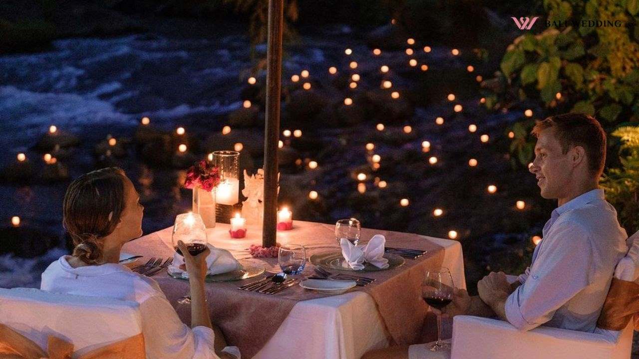 Romantic dinner by riverside with candlelight