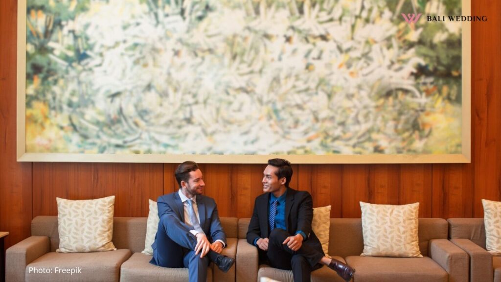 Two Smiling Business Men Chatting in Lounge