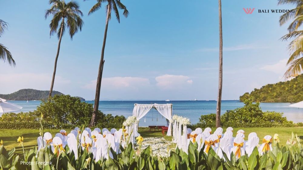 Beach wedding venue setting with coconut palm tree and panoramic ocean view