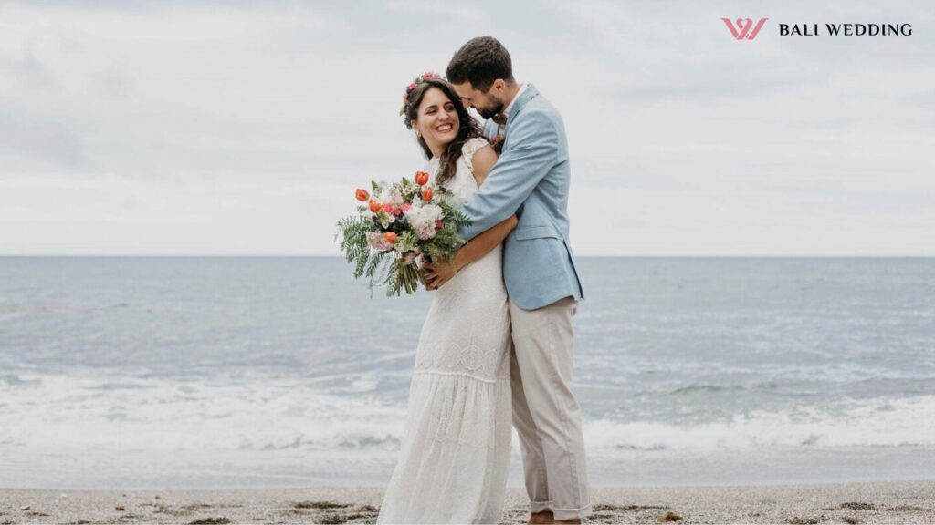 Beautiful husband and wife posing on the beach